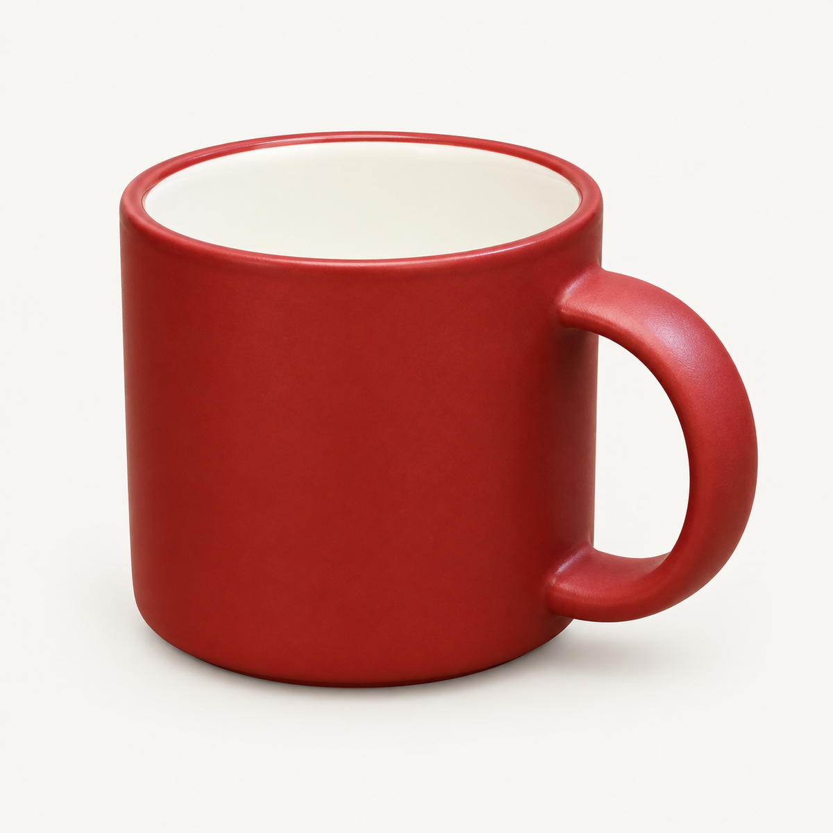 Red mug with cream interior and curved handle, front view